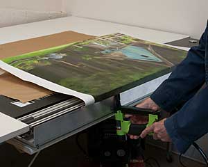 Paul stretches canvas by machine
